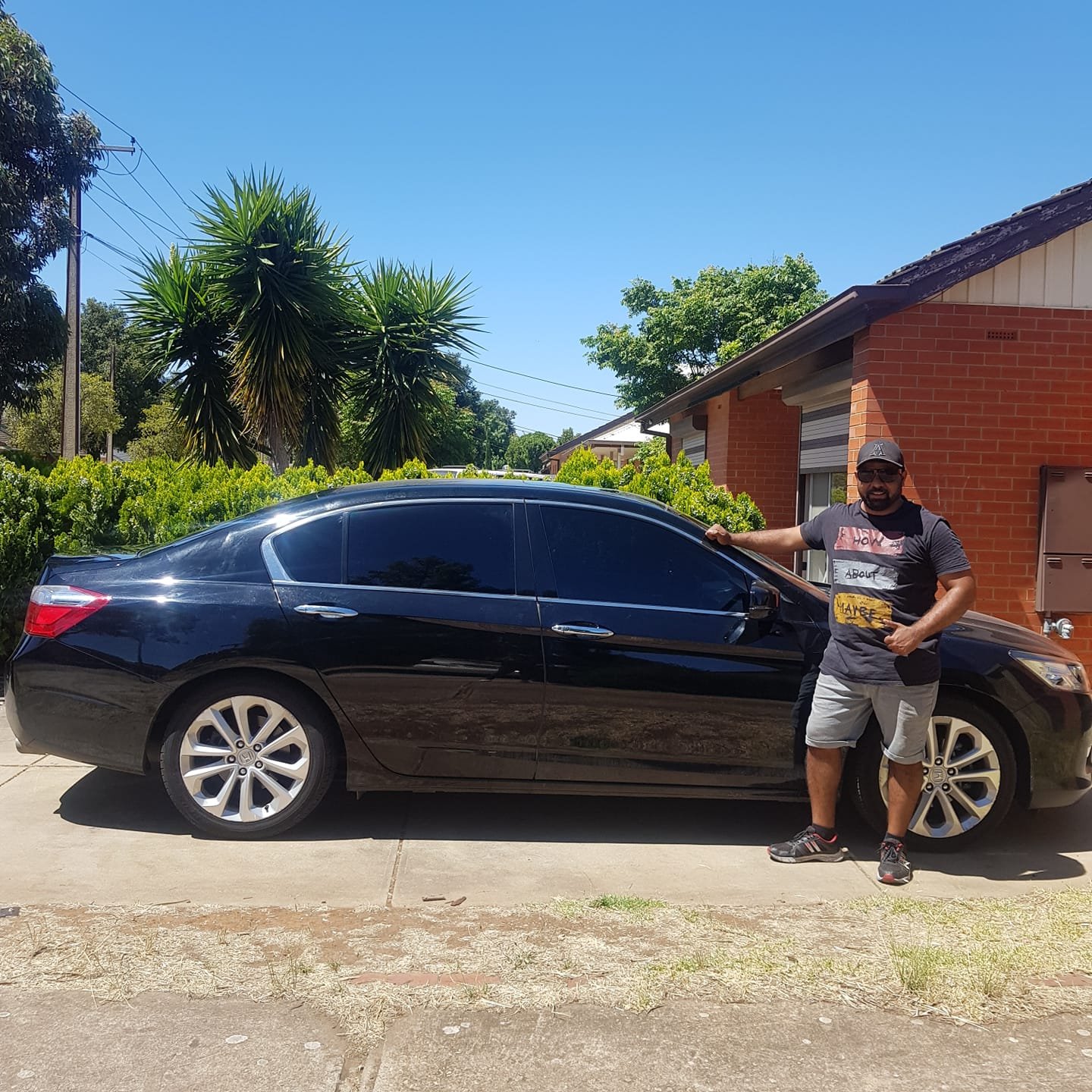 Alex Harry standing next to tinted car
